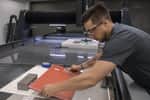 Operator removing composite material from OptiMAX 60X