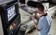 Image of waterjet employee holding a part