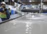 Image of worker spraying a waterjet table
