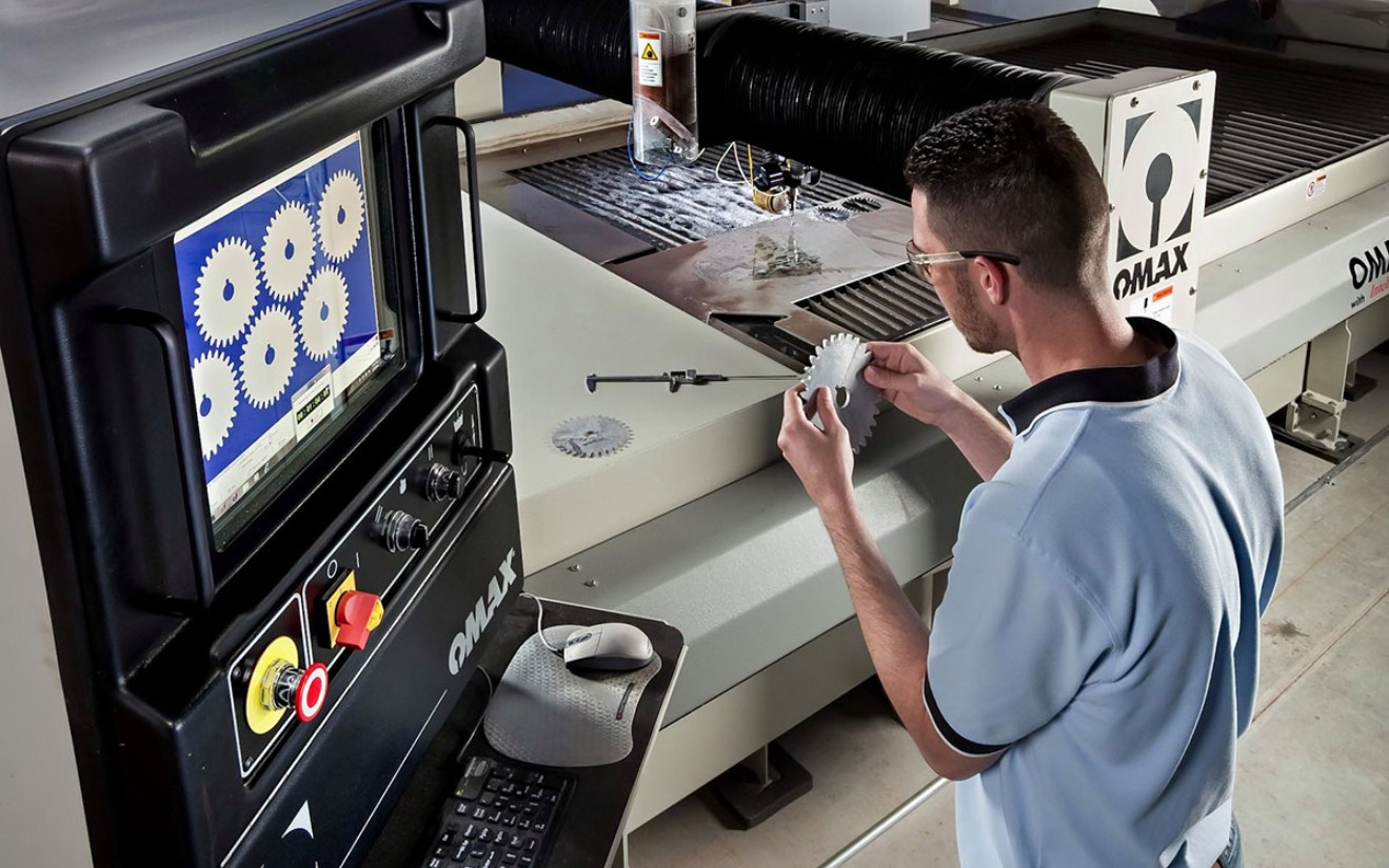 Image of waterjet employee holding a part